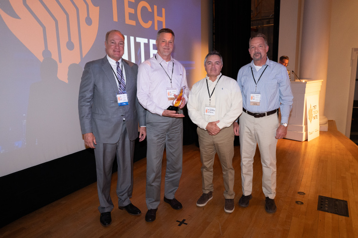 Psionic team members accept the Emerging Company award on stage at 757 TechNite.