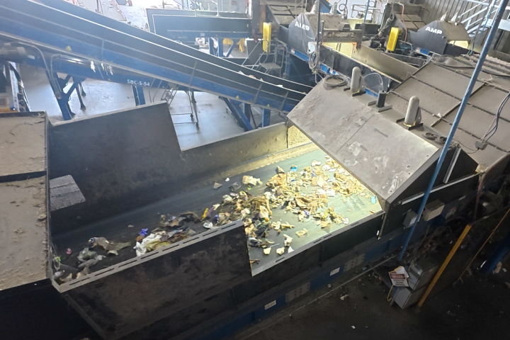 Household trash moving along conveyor belts inside AMP’s AI-powered waste sorting facility in Portsmouth, Virginia.