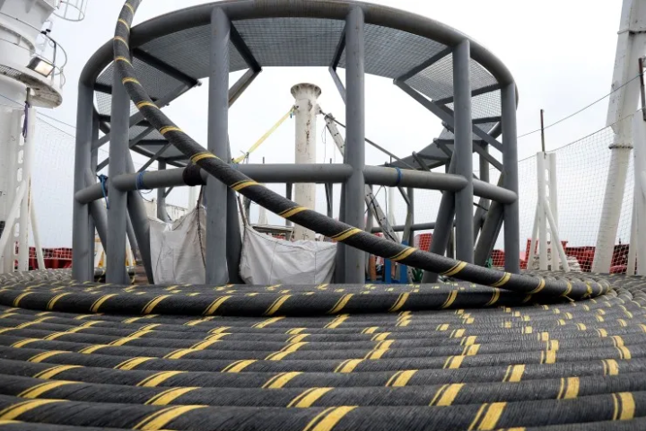 Large coils of LS Cable subsea power cable aboard an industrial vessel, representing high-voltage electrical infrastructure and energy manufacturing.