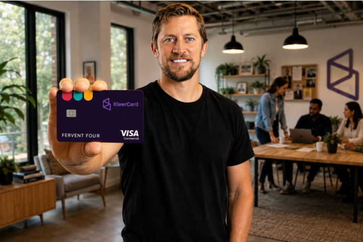 KleerCard founder and CEO Adam Alphin holds a Fervent Four branded KleerCard in a modern office setting.