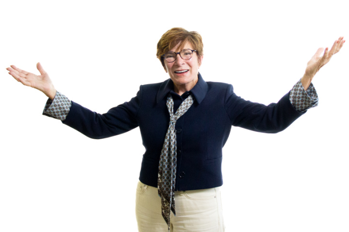 Marsha Hudgins of Hudgins Contracting smiling with her arms outstretched, featured on Fervent Four Episode 331.