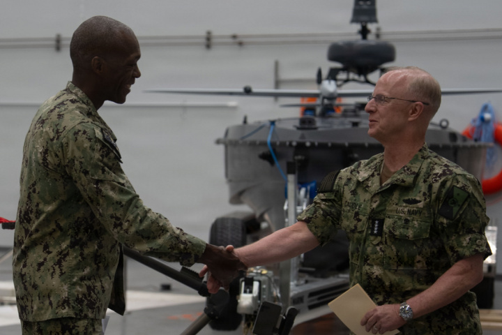 Adm. Daryl Caudle shakes hands with Rear Adm. Melvin Smith at the Navy robotics command’s launch at Little Creek.